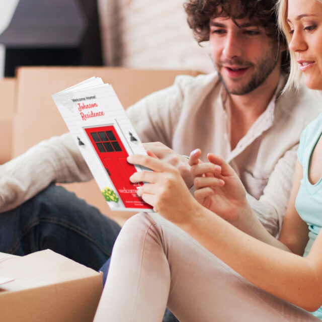 couple looking at moving information gift book