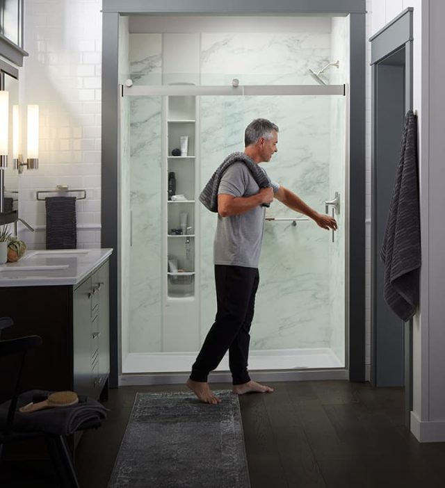 Man standing in Kohler Stone bathroom