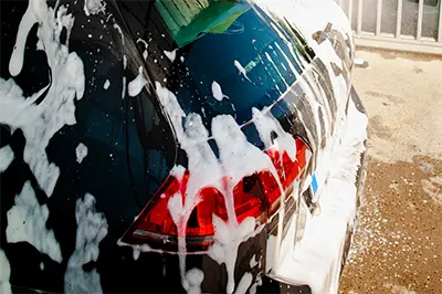 car covered in soap at a car wash