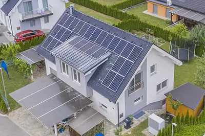 aerial shot of a house with solar panels on the roof