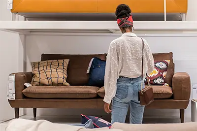 a woman browsing couches in a furniture store