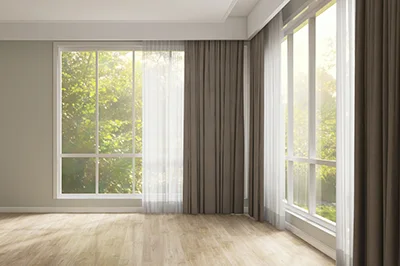 empty room with large windows and curtains